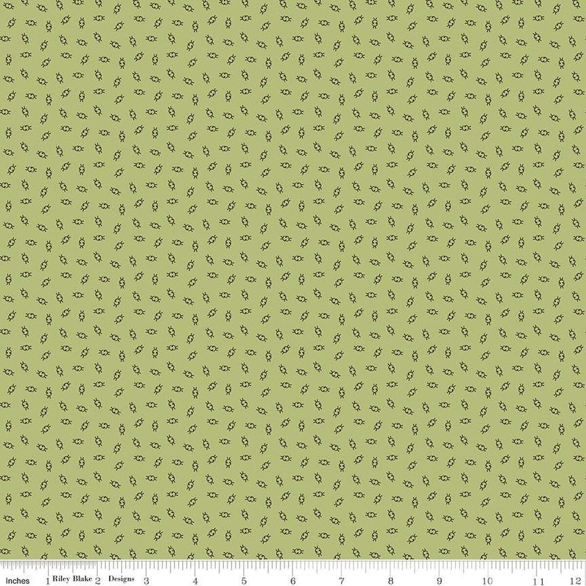 Green fabric with small blue and brown pattern.