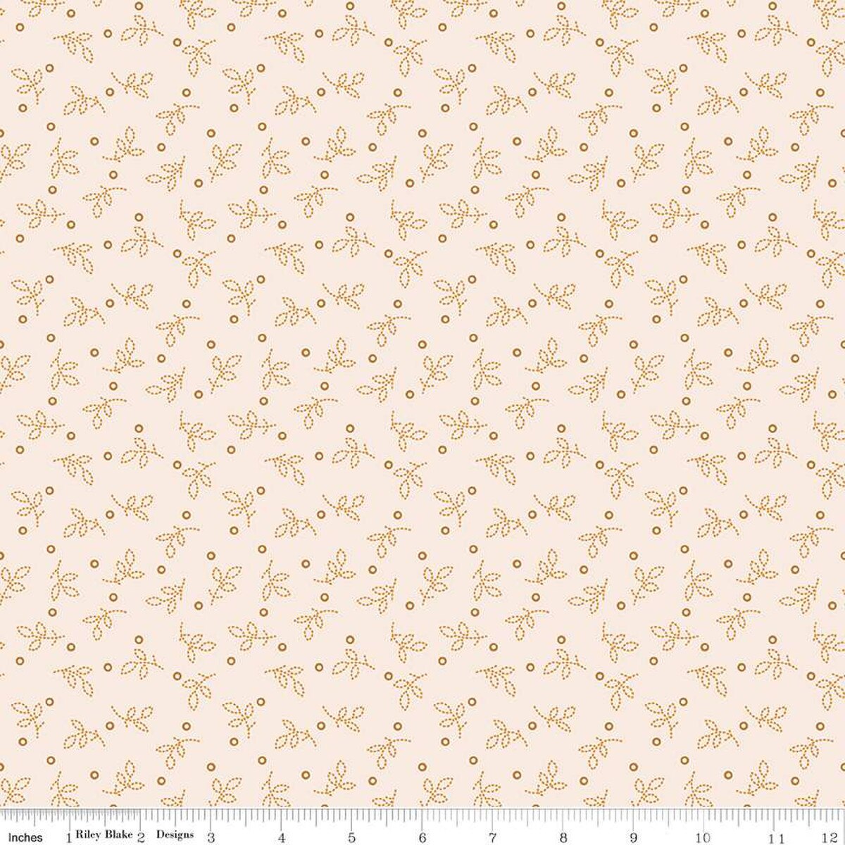 Fabric with a subtle pattern of small leaves and dots on a light pink background