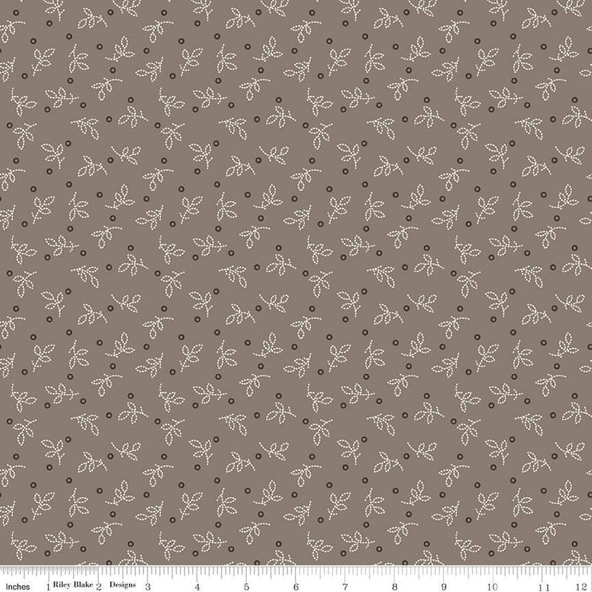 Fabric with small leaf pattern on a brown background