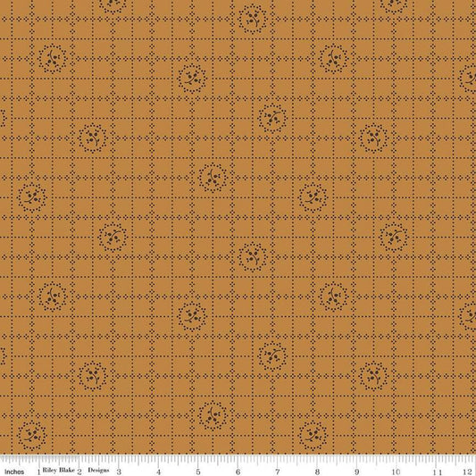 Fabric pattern with brown grid and geometric shapes on a brown background
