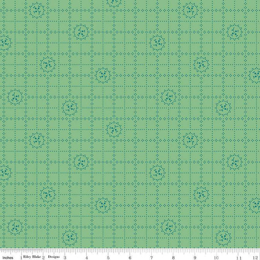 Green fabric with a grid and floral pattern
