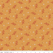 Floral pattern fabric with red and white flowers on a mustard yellow background