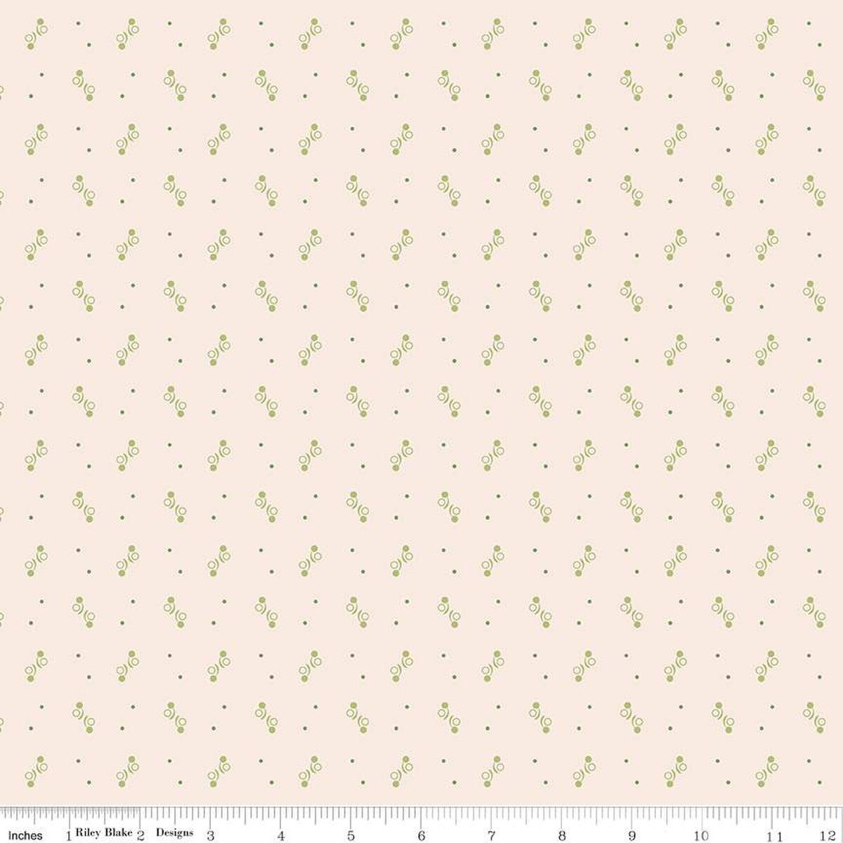 Fabric with small green geometric pattern  on a beige background.