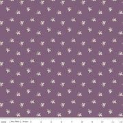 Fabric with small white floral pattern on a purple background