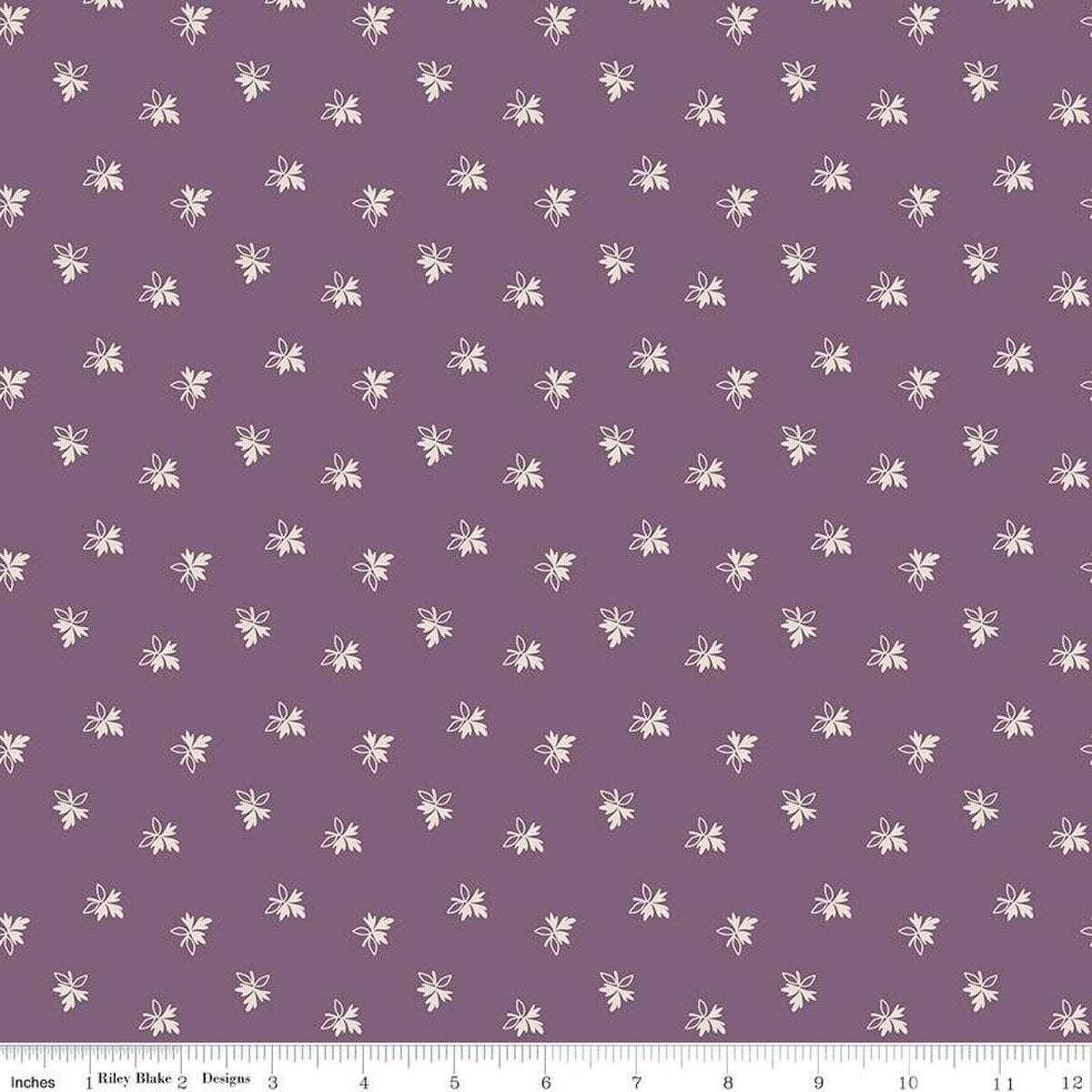Fabric with small white floral pattern on a purple background