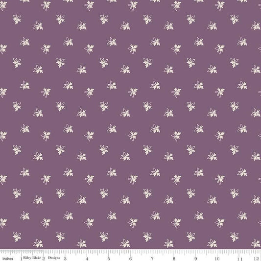 Fabric with small white floral pattern on a purple background
