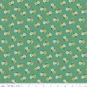 Floral pattern fabric with small white and gold flowers on a green background
