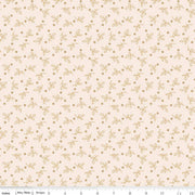 Fabric with a subtle pattern of small leaves and dots on a light pink background