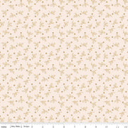 Fabric with a subtle pattern of small leaves and dots on a light pink background