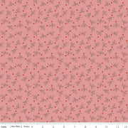Fabric with a small leaf and berry pattern on a pink background