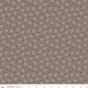 Fabric with small leaf pattern on a brown background