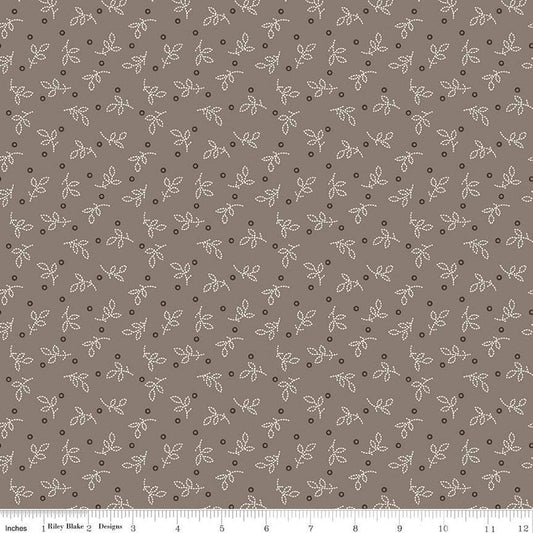 Fabric with small leaf pattern on a brown background
