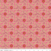 Floral patterned fabric with red and yellow flowers on a pink background