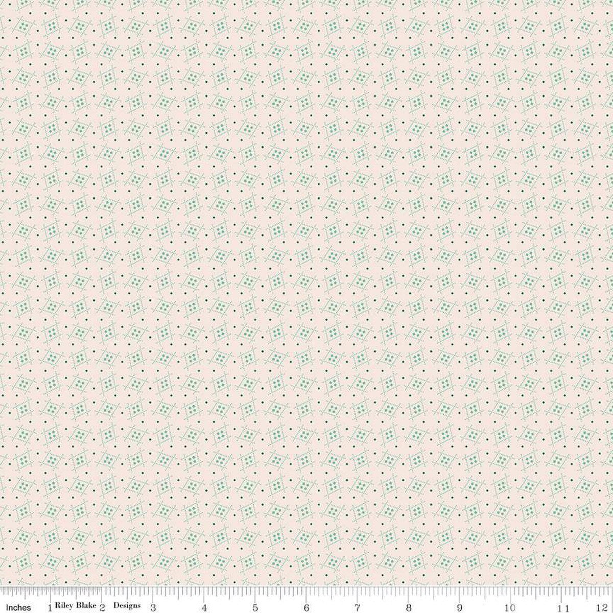 Floral patterned fabric with small green flowers on a light pink background