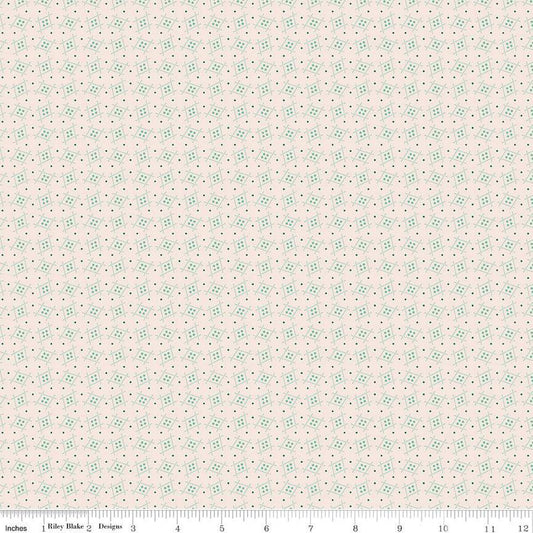 Floral patterned fabric with small green flowers on a light pink background