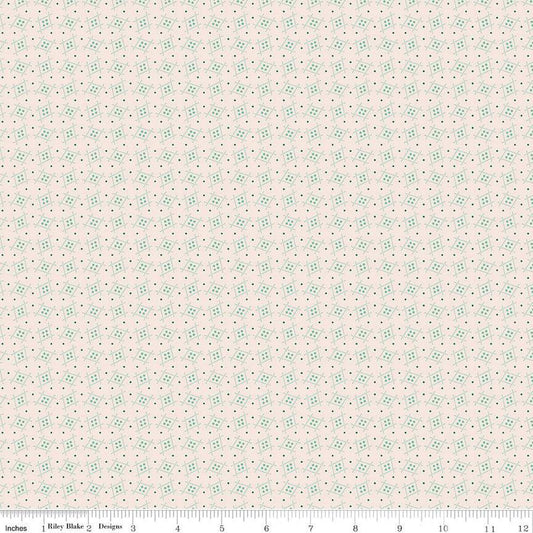 Floral patterned fabric with small green flowers on a light pink background